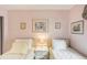 Guest bedroom with twin beds, neutral decor, and ample natural light at 3001 Seawind Cir # 10C, Venice, FL 34293