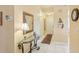 Condo entryway with a glass-top table, mirror, and tiled floor at 3001 Seawind Cir # 10C, Venice, FL 34293