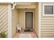 Condo entryway with a screened door and a white metal chair at 3001 Seawind Cir # 10C, Venice, FL 34293