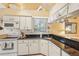 Bright kitchen features granite countertops, white cabinets, and modern appliances at 3001 Seawind Cir # 10C, Venice, FL 34293
