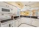 Well-equipped kitchen boasts granite counters, white cabinets, and ample workspace at 3001 Seawind Cir # 10C, Venice, FL 34293