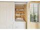Laundry room with washer, dryer, and shelving units at 3001 Seawind Cir # 10C, Venice, FL 34293