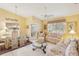 Bright living room with floral sofas, coffee table, and vaulted ceiling at 3001 Seawind Cir # 10C, Venice, FL 34293