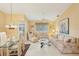 Bright living room with floral sofas, coffee table, and vaulted ceiling at 3001 Seawind Cir # 10C, Venice, FL 34293