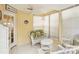 Bright sunroom with wicker furniture and large windows at 3001 Seawind Cir # 10C, Venice, FL 34293