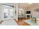 Living room featuring hardwood floors, a corner fireplace, and comfortable seating at 318 Star Shell Dr, Apollo Beach, FL 33572