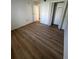Bedroom with vinyl flooring and mirrored closet doors at 3231 Beneva Rd # 103, Sarasota, FL 34232