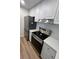Stainless steel appliances and white cabinetry in kitchen at 3231 Beneva Rd # 103, Sarasota, FL 34232