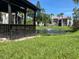 Serene pond view with lush landscaping and gazebo at 3231 Beneva Rd # 103, Sarasota, FL 34232