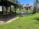 Peaceful pond with fountain, lush landscaping, and gazebo at 3231 Beneva Rd # 103, Sarasota, FL 34232