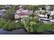 Aerial view showcasing a waterfront property with a pool and private dock at 3310 Sabal Cove Ln, Longboat Key, FL 34228