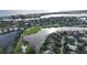An aerial view showcasing a luxurious waterfront home in a golf course community at 3310 Sabal Cove Ln, Longboat Key, FL 34228