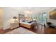 Main bedroom with hardwood floors, large windows, and private access to balcony at 3310 Sabal Cove Ln, Longboat Key, FL 34228
