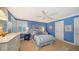 Blue bedroom with a double bed and white dresser at 3310 Sabal Cove Ln, Longboat Key, FL 34228