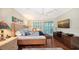 Spacious bedroom with hardwood floors, a large window, and lots of natural light at 3310 Sabal Cove Ln, Longboat Key, FL 34228
