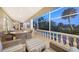 Spacious covered patio with outdoor furniture and water views at 3310 Sabal Cove Ln, Longboat Key, FL 34228