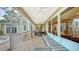 Relaxing covered patio with seating area, adjacent to pool and kitchen at 3310 Sabal Cove Ln, Longboat Key, FL 34228