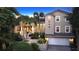Stunning two-story home with a three-car garage and lush landscaping at 3310 Sabal Cove Ln, Longboat Key, FL 34228