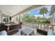 Screened lanai with pool view and wicker furniture at 3310 Sabal Cove Ln, Longboat Key, FL 34228