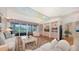 Elegant living room with hardwood floors, built-in shelving, and a large TV at 3310 Sabal Cove Ln, Longboat Key, FL 34228