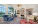 Relaxing living room with fireplace, built-in shelving, and water views at 3310 Sabal Cove Ln, Longboat Key, FL 34228