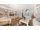 Spacious living room with hardwood floors, built-in shelving, and large windows at 3310 Sabal Cove Ln, Longboat Key, FL 34228