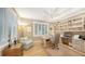 Bright home office features built-in shelving, hardwood floors, and large windows at 3310 Sabal Cove Ln, Longboat Key, FL 34228