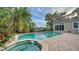 Inviting pool and spa with brick patio, lush landscaping at 3310 Sabal Cove Ln, Longboat Key, FL 34228