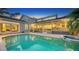 Stunning pool and spa at twilight, adjacent to home at 3310 Sabal Cove Ln, Longboat Key, FL 34228