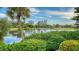 Scenic water view with lush landscaping and palm trees at 3310 Sabal Cove Ln, Longboat Key, FL 34228