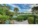 Peaceful water view with lush landscaping and gorgeous sunset at 3310 Sabal Cove Ln, Longboat Key, FL 34228