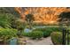 Serene water view with colorful sunset and tropical foliage at 3310 Sabal Cove Ln, Longboat Key, FL 34228