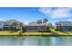 Aerial view of a house with a screened pool overlooking a lake at 3431 Chestertown Loop, Bradenton, FL 34211