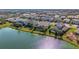 Aerial view of upscale homes and a glistening lake at 3431 Chestertown Loop, Bradenton, FL 34211