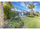 Landscaped backyard with tropical plants and pool at 3431 Chestertown Loop, Bradenton, FL 34211