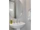 Small bathroom with pedestal sink, oval mirror, and white towel at 3431 Chestertown Loop, Bradenton, FL 34211