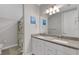 Bathroom boasts double vanity and a patterned shower curtain at 3431 Chestertown Loop, Bradenton, FL 34211
