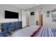 Bedroom with a navy dresser, blue chair, and a large TV at 3431 Chestertown Loop, Bradenton, FL 34211