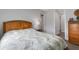 Bright bedroom featuring a wood bed frame and leafy patterned bedding at 3431 Chestertown Loop, Bradenton, FL 34211