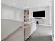 Upstairs bonus room features built-in shelving and a large TV at 3431 Chestertown Loop, Bradenton, FL 34211
