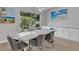 Bright dining area with marble table and modern chairs, offering views to the backyard at 3431 Chestertown Loop, Bradenton, FL 34211