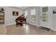 Elegant entryway with piano, wood-look tile floors, and a glass door at 3431 Chestertown Loop, Bradenton, FL 34211