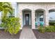 Front entry with stone pillars, a gray door, and a brick walkway at 3431 Chestertown Loop, Bradenton, FL 34211