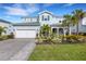 Two-story home with light blue exterior, stone accents, and landscaped yard at 3431 Chestertown Loop, Bradenton, FL 34211
