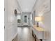 Bright hallway with light wood-look tile floor and built-in console at 3431 Chestertown Loop, Bradenton, FL 34211