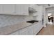 White kitchen with gas range and diamond patterned backsplash at 3431 Chestertown Loop, Bradenton, FL 34211
