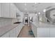 Kitchen with white cabinets, granite counters, and gas cooktop at 3431 Chestertown Loop, Bradenton, FL 34211