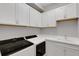 Clean laundry room with white cabinets and countertop at 3431 Chestertown Loop, Bradenton, FL 34211