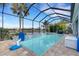 Enclosed pool and spa with lake view and paver deck at 3431 Chestertown Loop, Bradenton, FL 34211