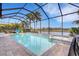 Enclosed pool and spa with lake view and paver deck at 3431 Chestertown Loop, Bradenton, FL 34211